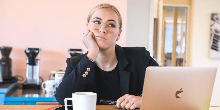 Woman Looking Annoyed Working on Laptop